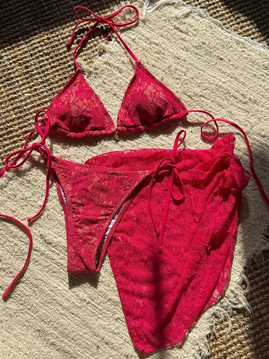 Red bikini set on a textured beige surface