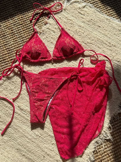 Red bikini set on a textured beige surface