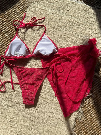 Red bikini set with white accents on a textured surface BIKINISEXZY summer beachwear collection 3-piece set