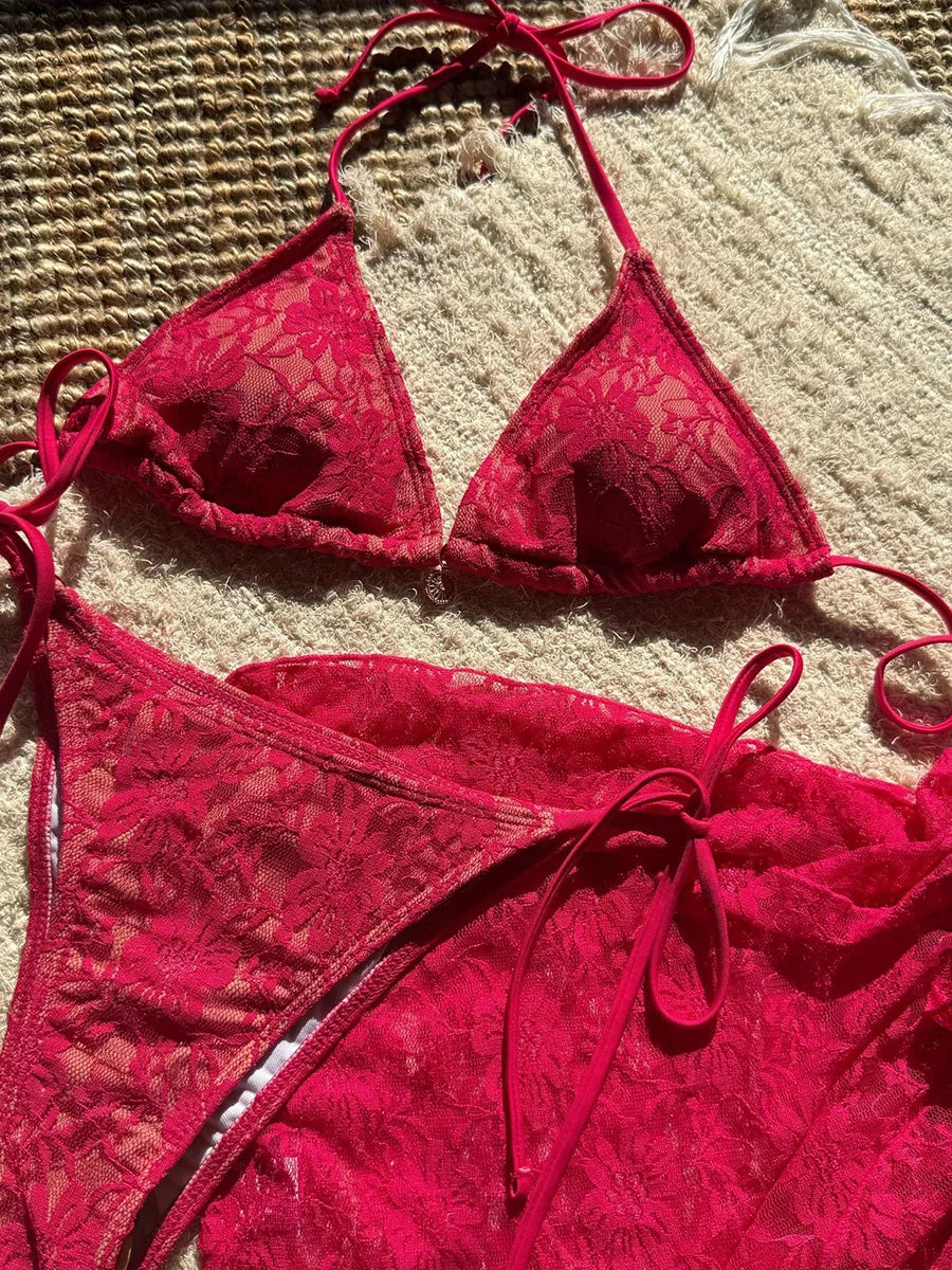 Red lace bikini set on a textured surface
