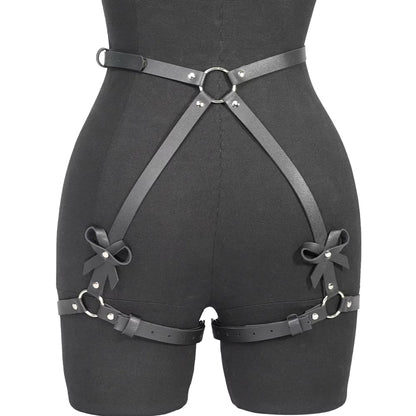 Black leather harness with bow details on a mannequin against a Bikinisexzy 