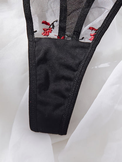 Bikinisexzy Close-up of a garment with black mesh and red floral embroidery on a white background