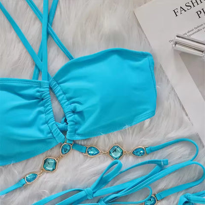 Turquoise bikini top with decorative straps on a textured surface Bikinisexzy