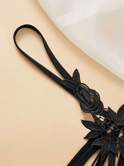 Close-up shot of adjustable ribbon tie-side straps on black lace thong - Bikinisexzy | Bikinisexzy.com