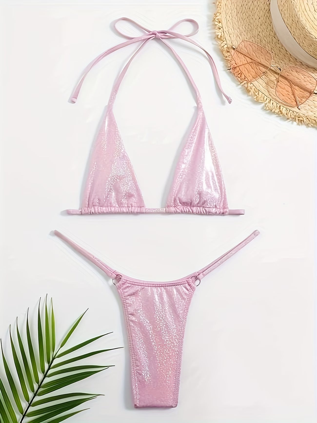 Pink bikini set with a straw hat and BIKINISEXZY comfortable halter neck swimsuit design leaves on a white background 