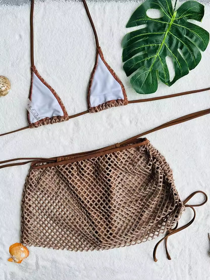 Brown bikini top and mesh shorts on a white surface with green leaves. BIKINISEXZY summer holiday beach bikini set