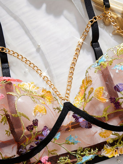 bikinisexzy Close-up of a floral embroidered lingerie set with gold chain details.