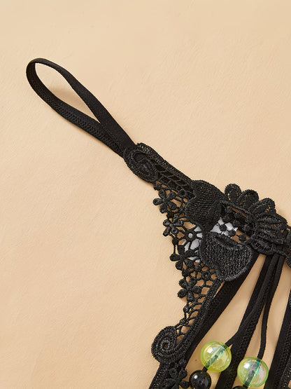 Close-up of intricate black floral lace waistband on Bikinisexzy glow-in-the-dark pearl thong panties