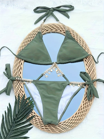 Green chain charm bikini set flat lay on rattan mirror with tropical palm leaves | bikinisexzy