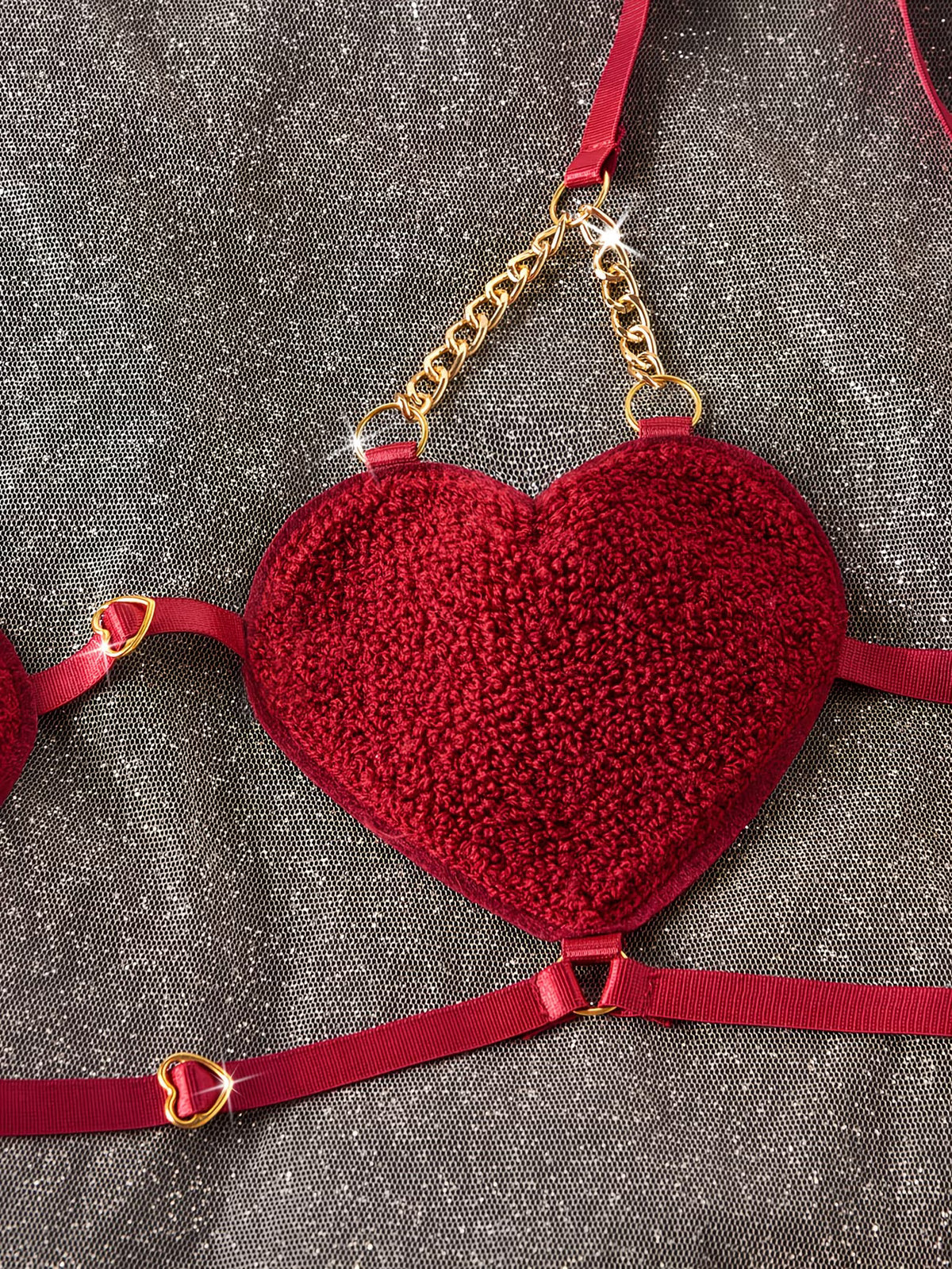 Red heart-shaped bralette with gold chain and heart details | Close-up shot of burgundy red heart-shaped bra cup - Bikinisexzy | Bikinisexzy.com