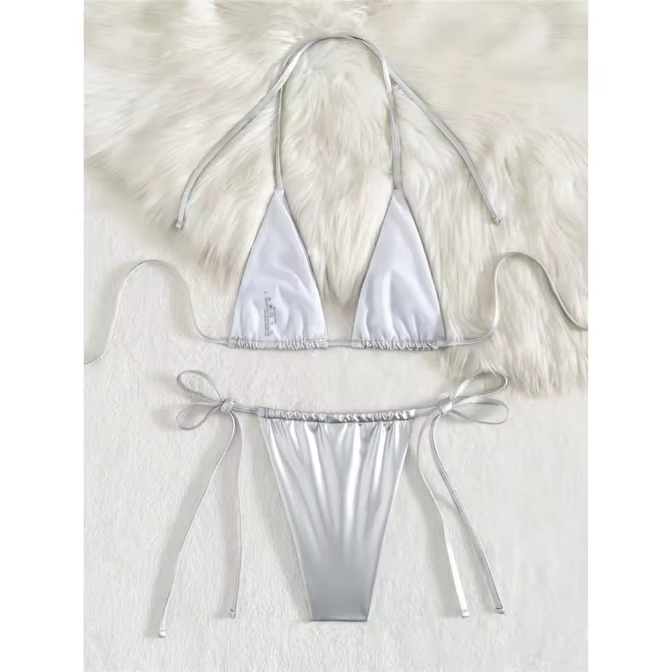 Silver bikini set on a white fur background