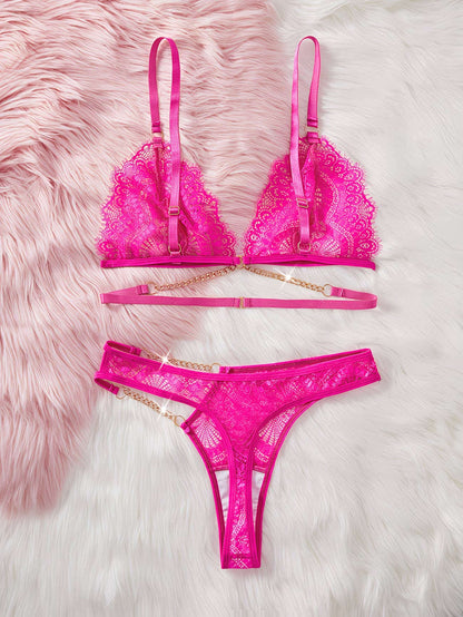 Pink lace lingerie set on a fluffy pink surface | Flat lay view displaying hot pink geometric lace bra and thong set - Bikinisexzy | Bikinisexzy.com