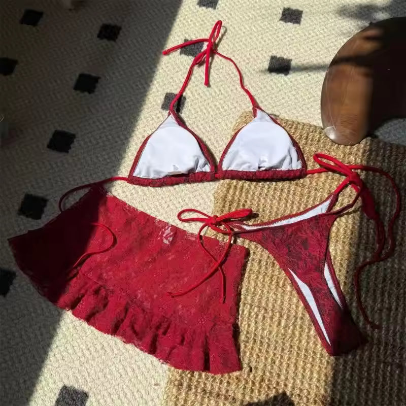 Red bikini set with white accents on a textured surface BIKINISEXZY sexy 3-piece hollow-out tankini set front view