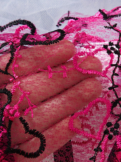 Close-up of sheer pink and black embroidered heart lace fabric - Bikinisexzy