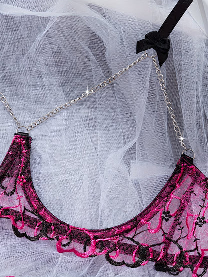 Close-up of decorative silver chain detail on pink and black lace bralette - Bikinisexzy