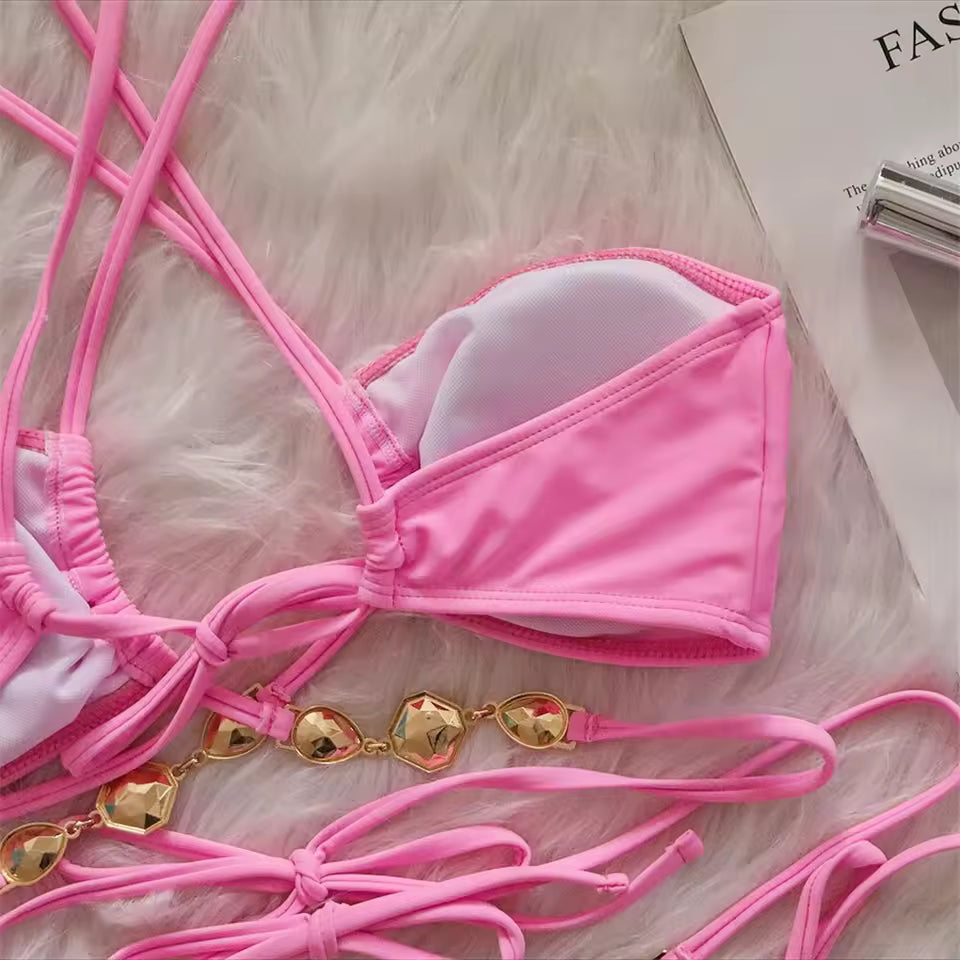 Bikinisexzy Pink bikini set with gold chain on a textured surface
