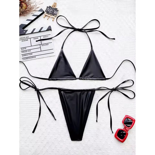 Black bikini set with red sunglasses on a white background. BIKINISEXZY bold black faux leather look bikini