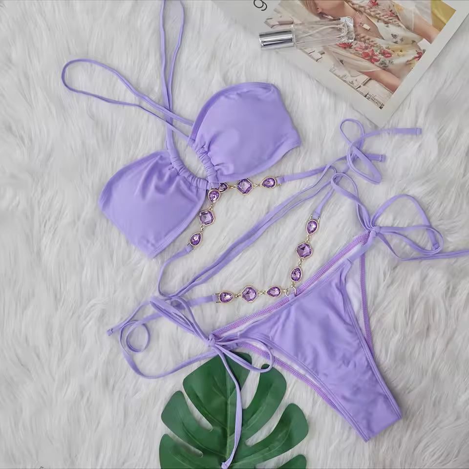 Purple bikini set with decorative elements on a textured surface.BIKINISEXZY Purple Criss-Cross Halter Bikini Set