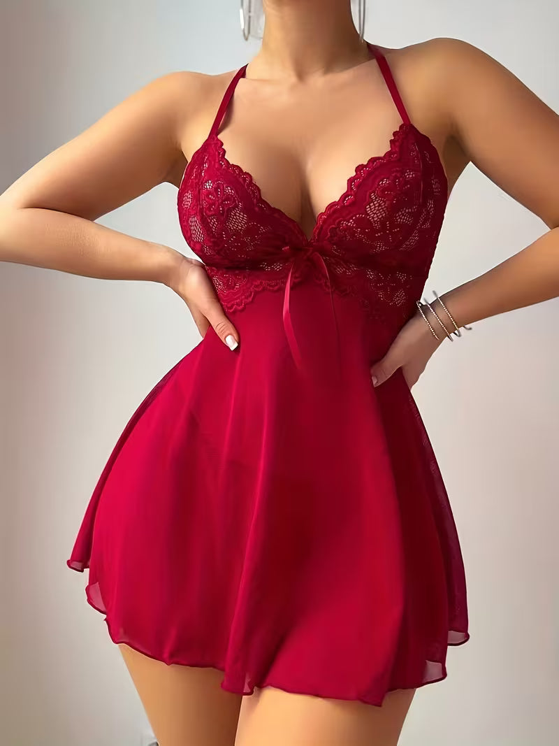 Red lace nightgown worn by a person on a plain background Front angle view showcasing side cut-out netting panels and spaghetti straps on red babydoll sleepwear - Bikinisexzy 