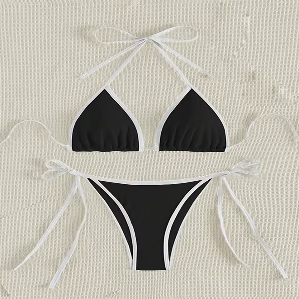 Black bikini set with white strings on a beige textured and BIKINISEXZY triangle thong two-piece swimsuit design