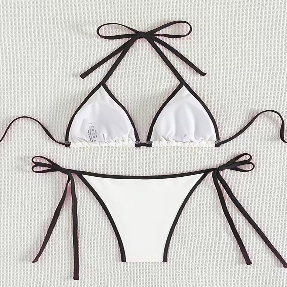 White bikini set with black straps high quality BIKINISEXZY tie on side sexy beach bikini set on a light background. 