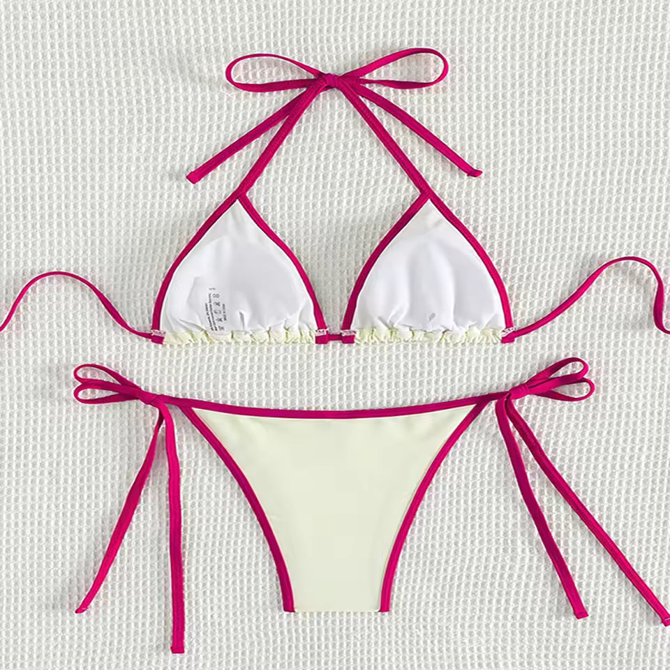 White bikini with pink straps on a textured white background. BIKINISEXZY low waist brazilian biquini swimwear