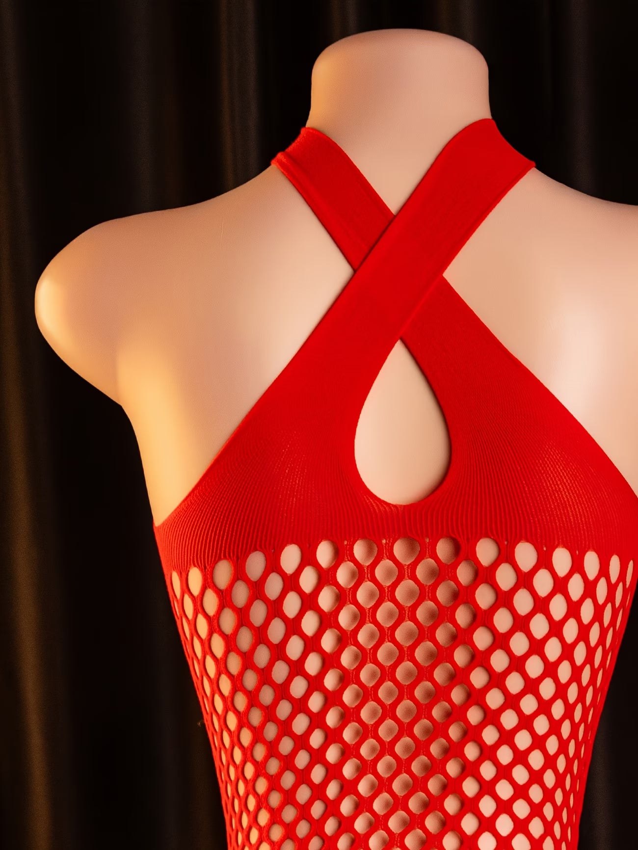 Back view of the red fishnet bodystocking featuring an elegant strap design at Bikinisexzy.com