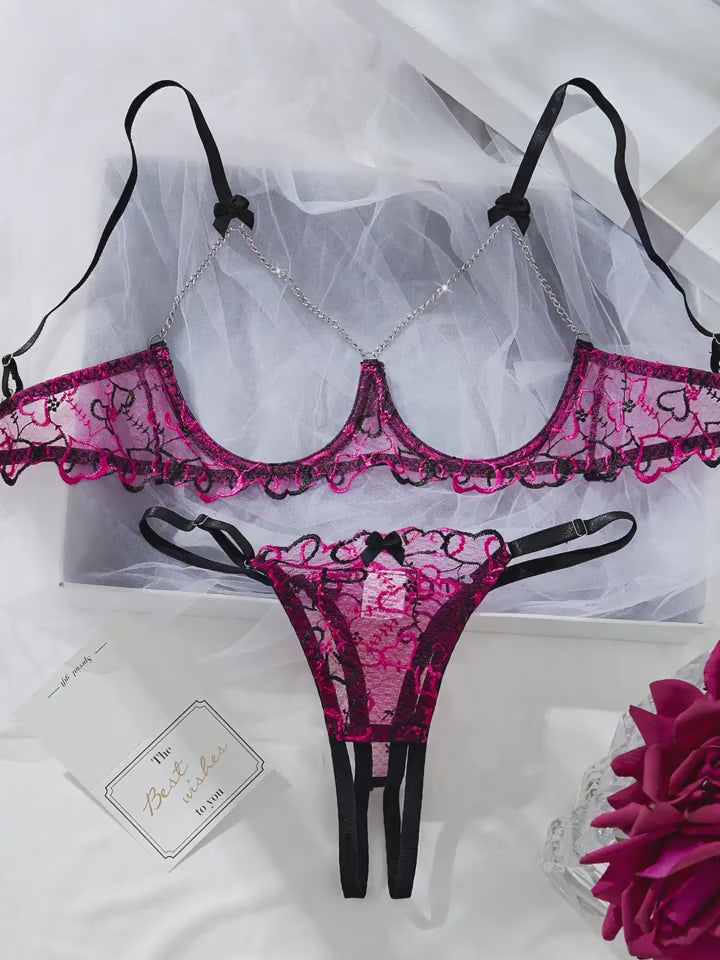Flat lay back view displaying adjustable straps and back closure on lace bralette set