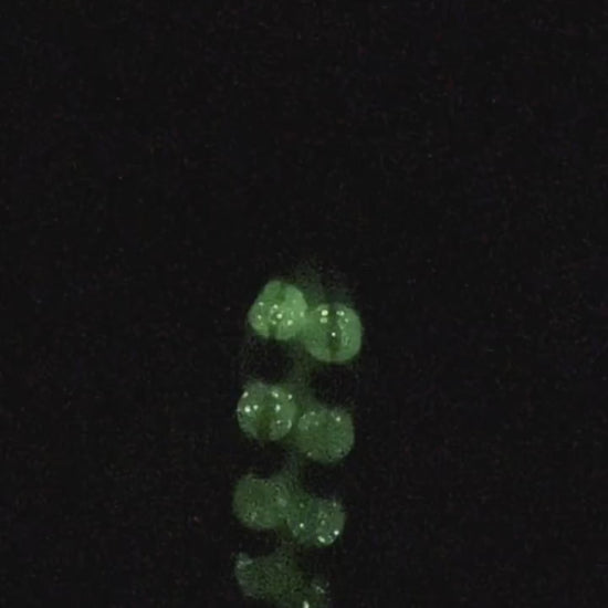 Detailed close-up shot of luminous green glow-in-the-dark crystal beads - Bikinisexzy | Bikinisexzy.com