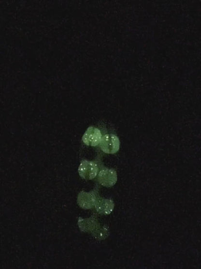 Detailed close-up shot of luminous green glow-in-the-dark crystal beads - Bikinisexzy | Bikinisexzy.com